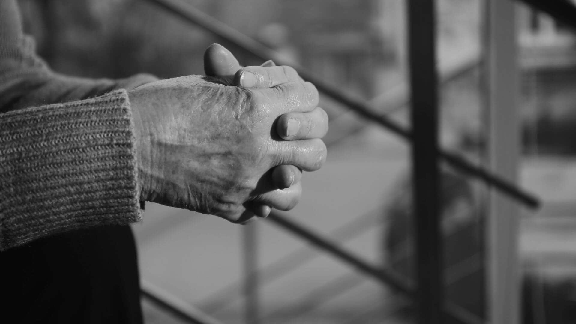 The clasped hands of an older Texan.