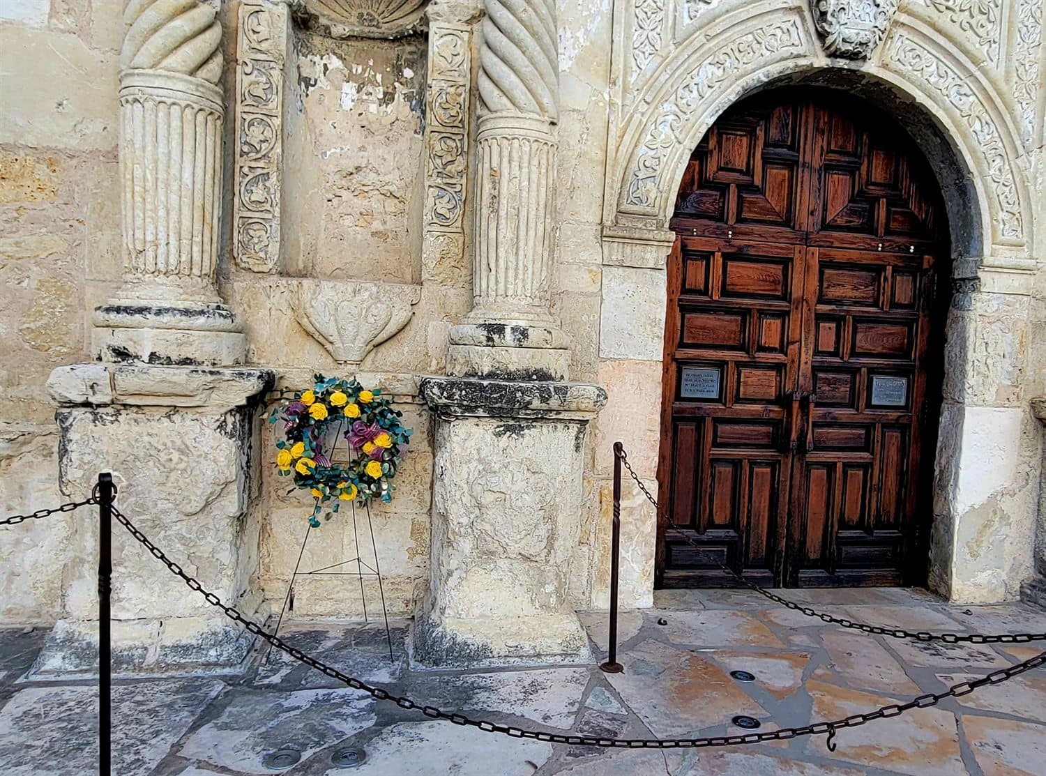 A Texas Nationalist Movement memorial wreath beside the chapel doors at the Alamo.