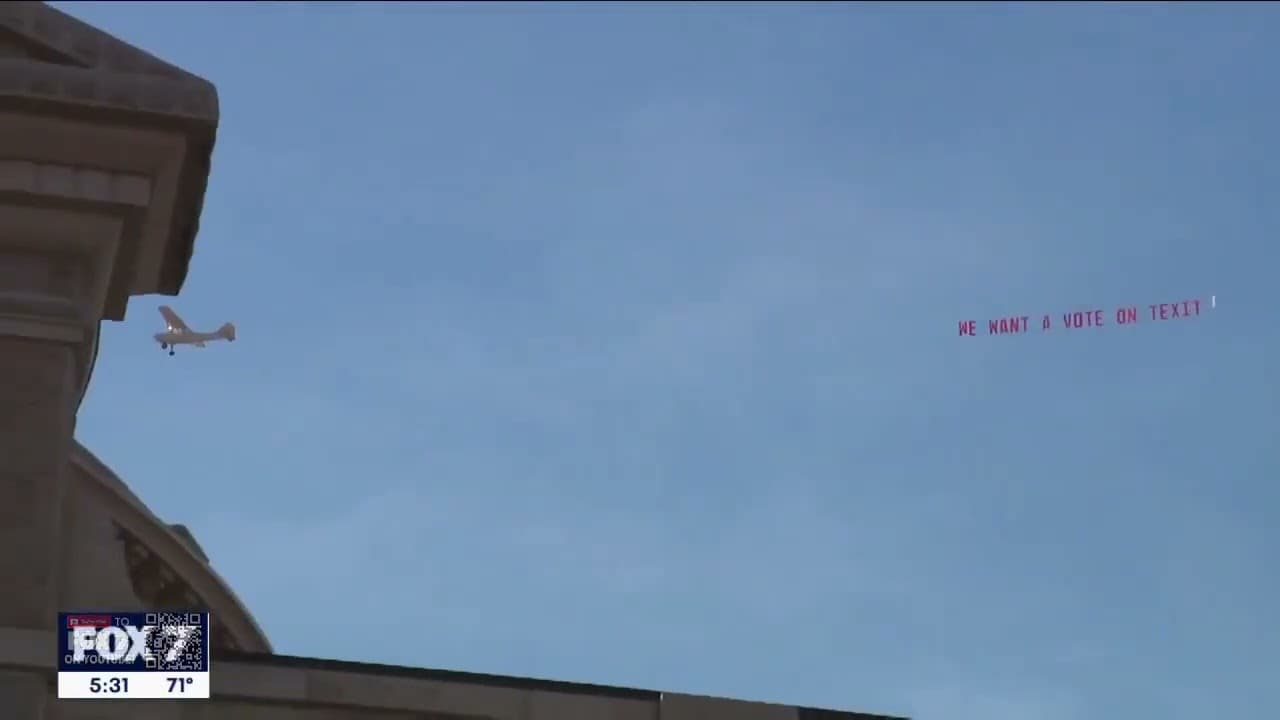 A small plane towing a banner reading 'WE WANT A VOTE ON TEXIT' past the Texas Capitol, captured by Fox 7 Austin.