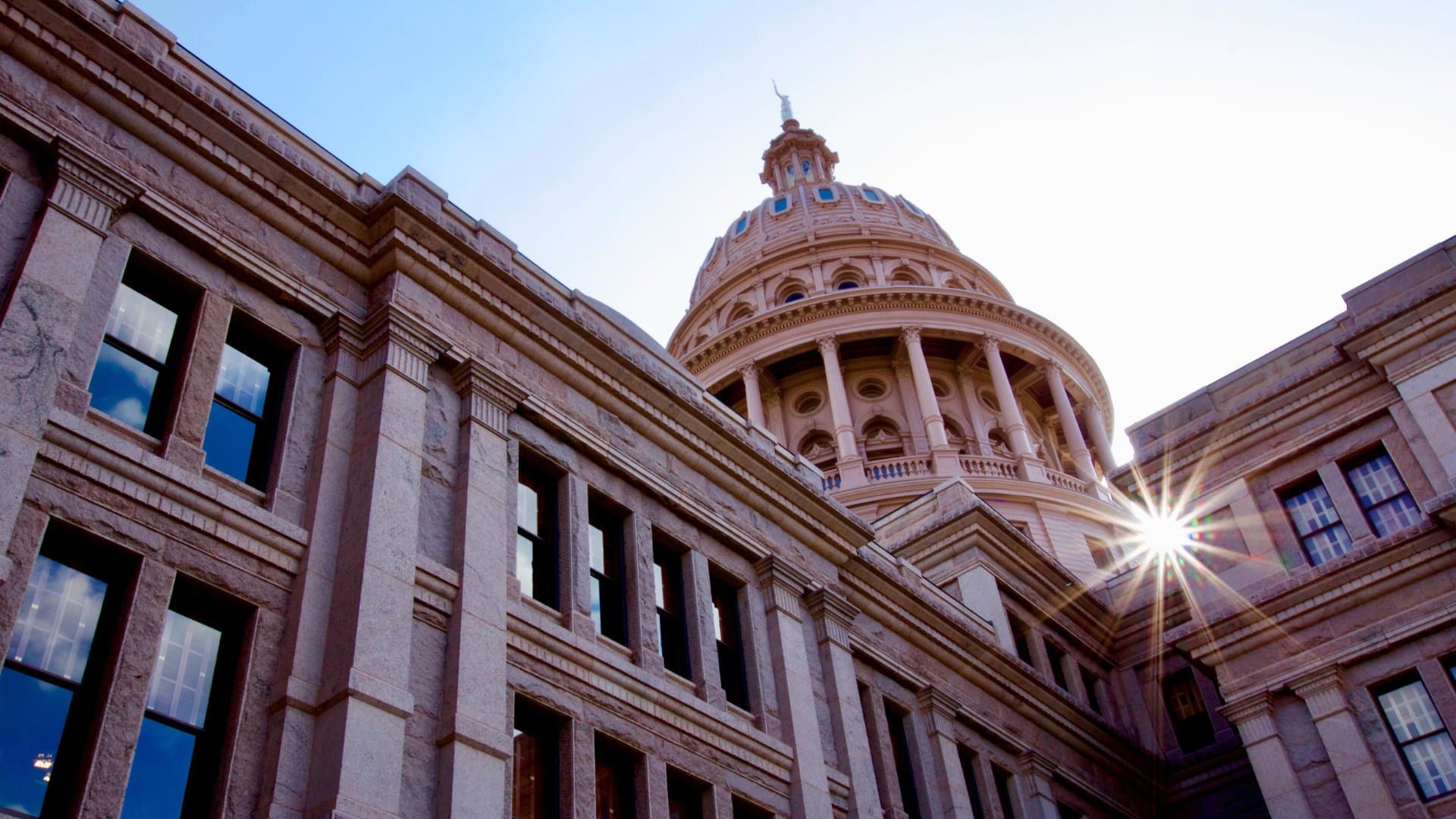 The Texas State Capitol dome rising above the building.