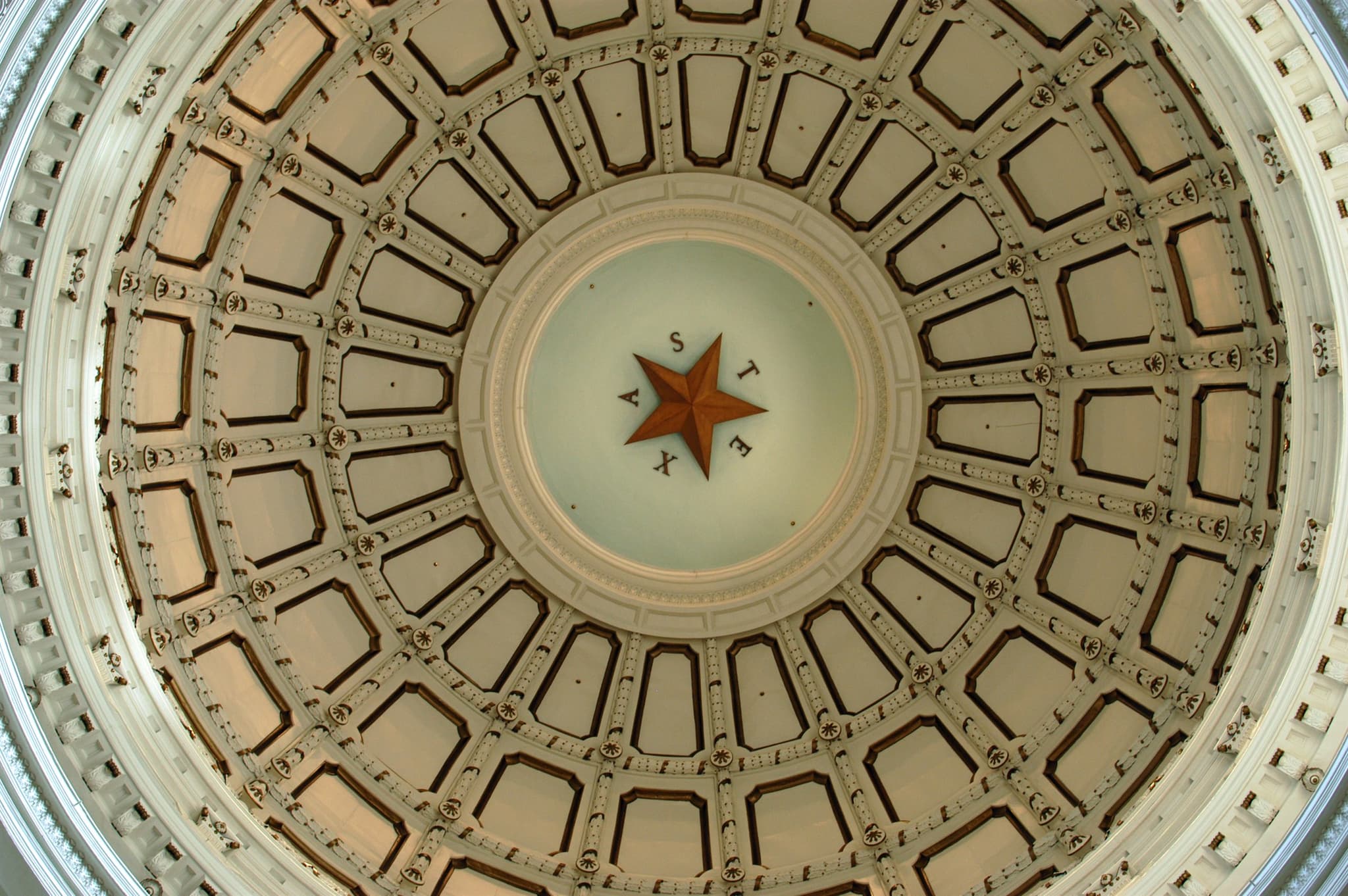 The interior of the Texas State Capitol dome, the lone star at its center.